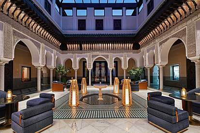Peaceful interior courtyard of a luxury Modern Riad in Marrakech, featuring a small pool and traditional tiling. Riad stay Marrakech.